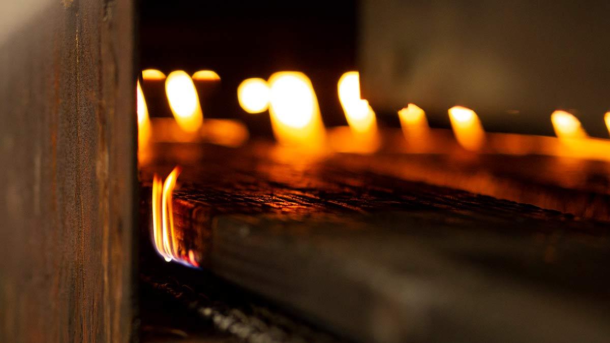 A man holding a fire torch and burning a big piece of oak creating flames  and smoke, old jappanese shou sugi ban technique. black wooden material.  Gra Stock Photo - Alamy